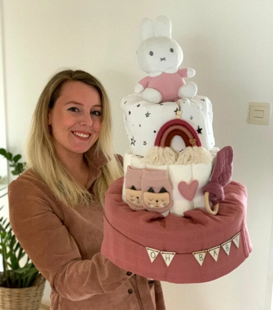 webbabyshower image from instagram mom holding a diaper cake