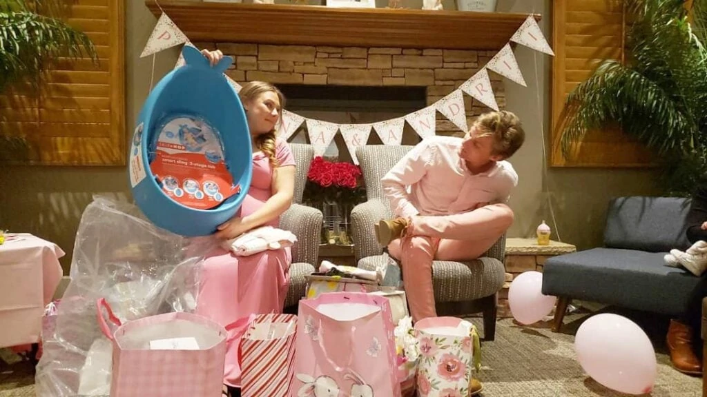 webbabyshower image from instagram mom with dad opening gifts