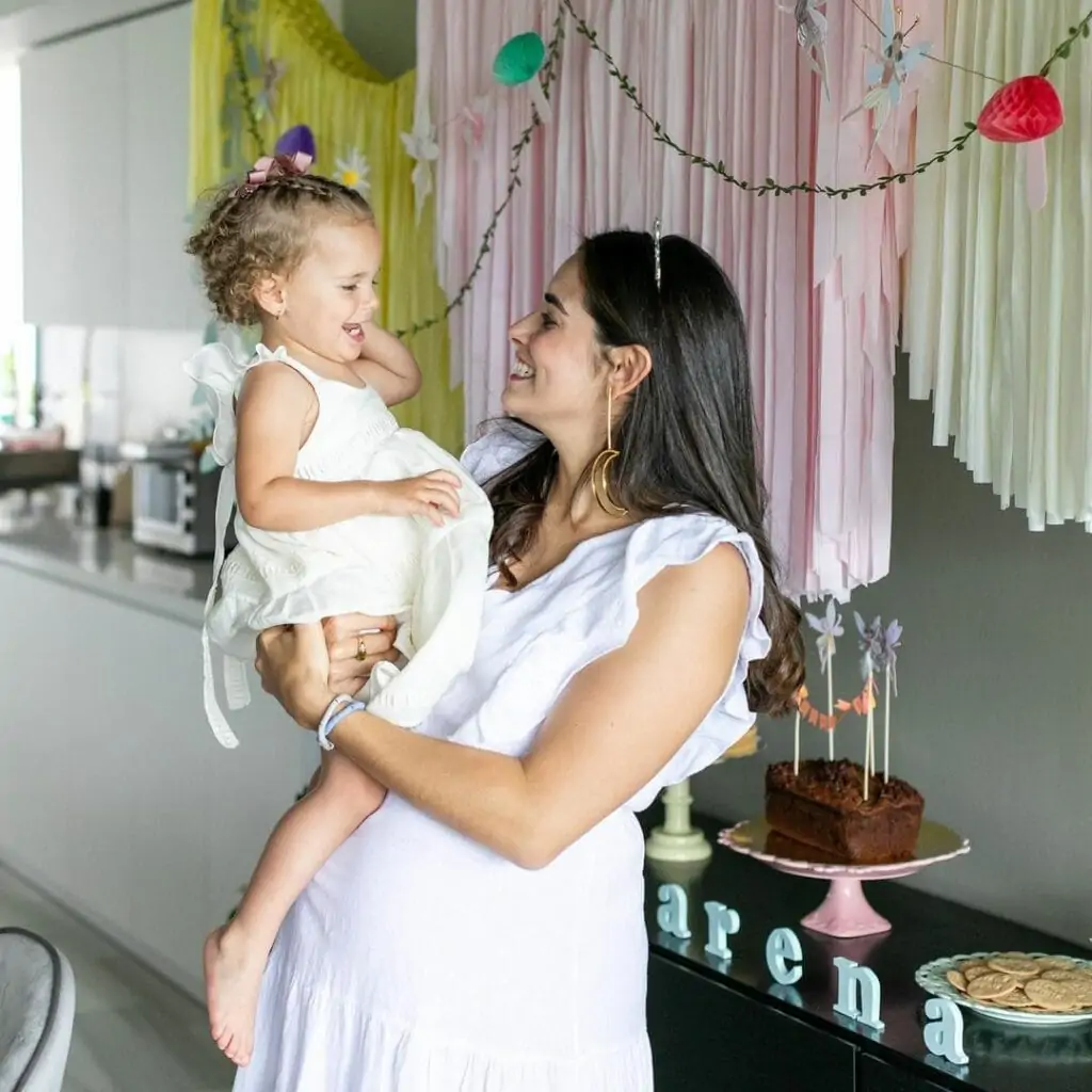 mom holding her daughter during baby sprinkle