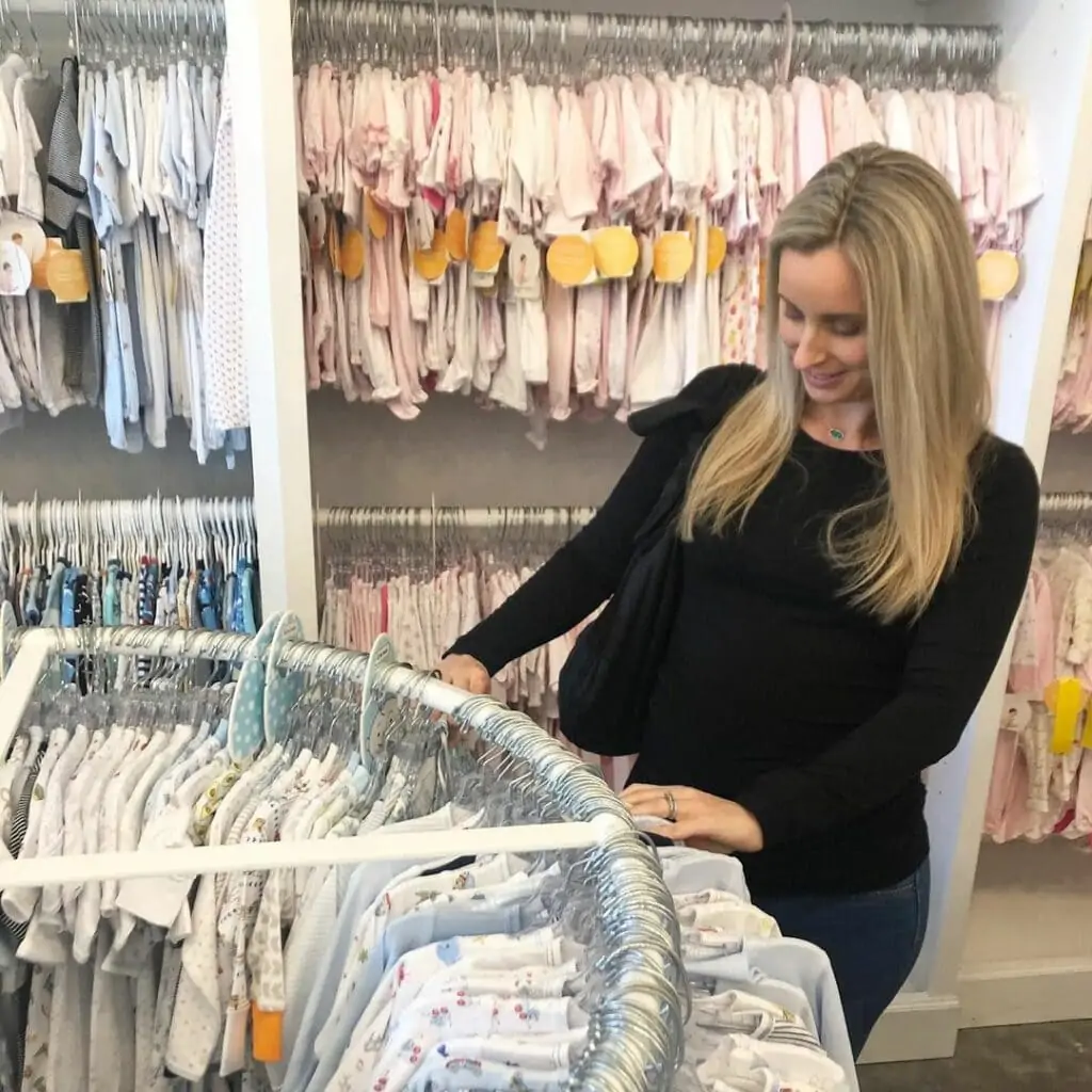 mom to be shopping for baby clothes