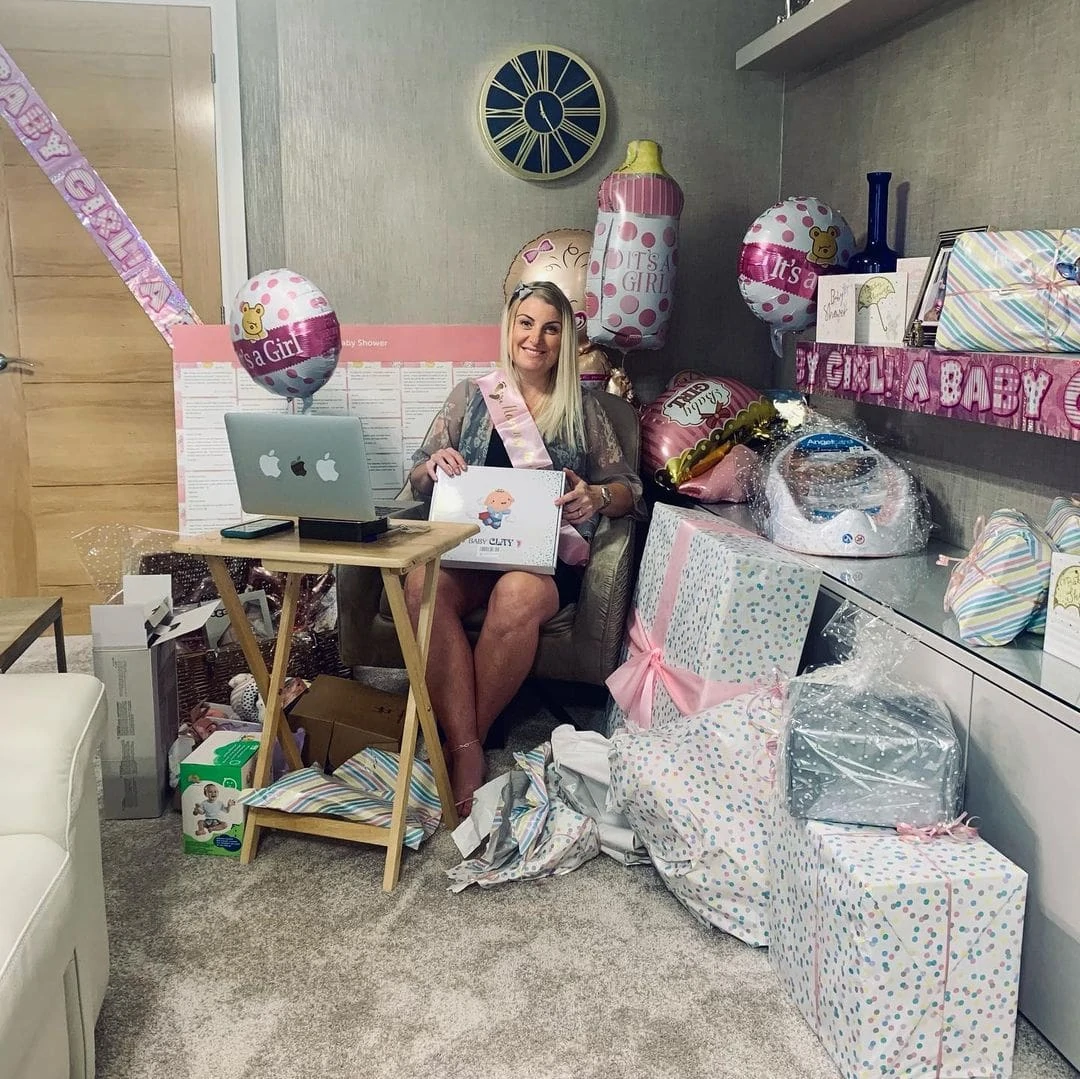 virtual work baby shower mom with laptop and gifts