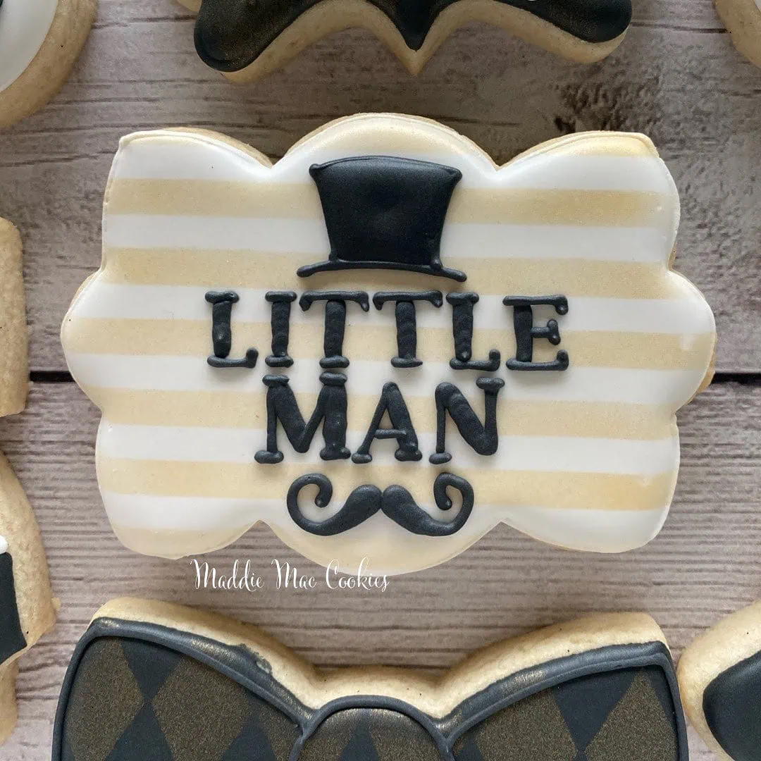 a picture of a little man baby shower cookies made by Maddie Mae Cookies in Florida