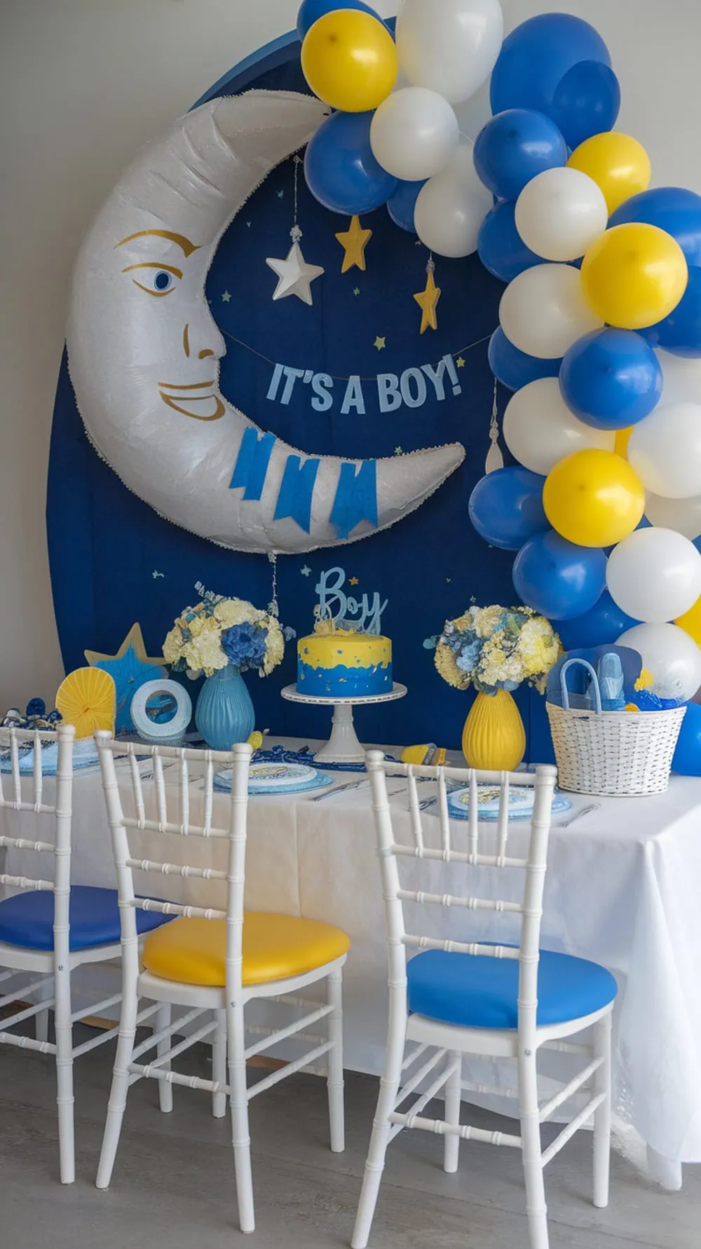 Moon and stars themed baby shower setup with blue and yellow decorations.